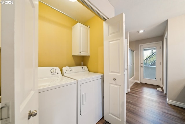 laundry room with cabinet space, baseboards, dark wood-style floors, and separate washer and dryer