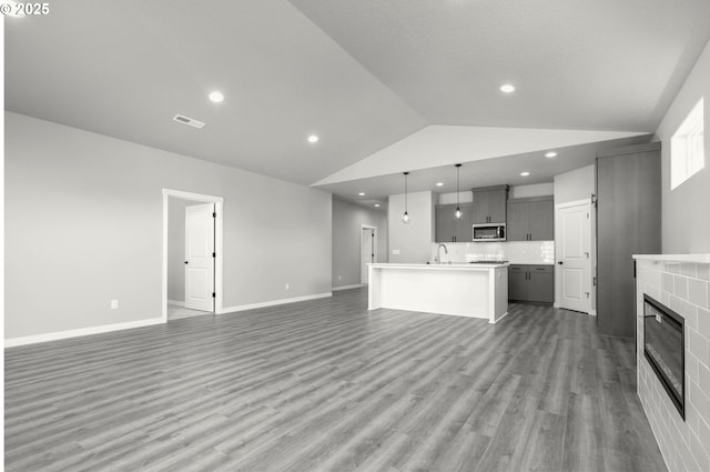 12812 NE 109th St, Vancouver, WA 98682 - unfurnished living room featuring visible vents, a sink, lofted ceiling, recessed lighting, and light wood-style flooring