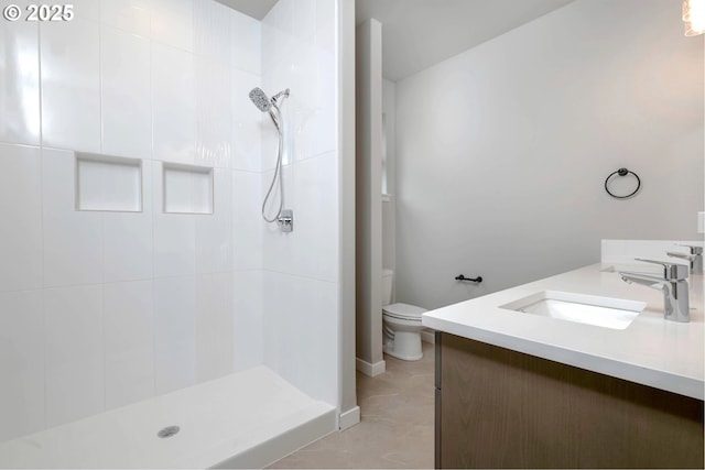 12812 NE 109th St, Vancouver, WA 98682 - bathroom featuring vanity, baseboards, a tile shower, and toilet