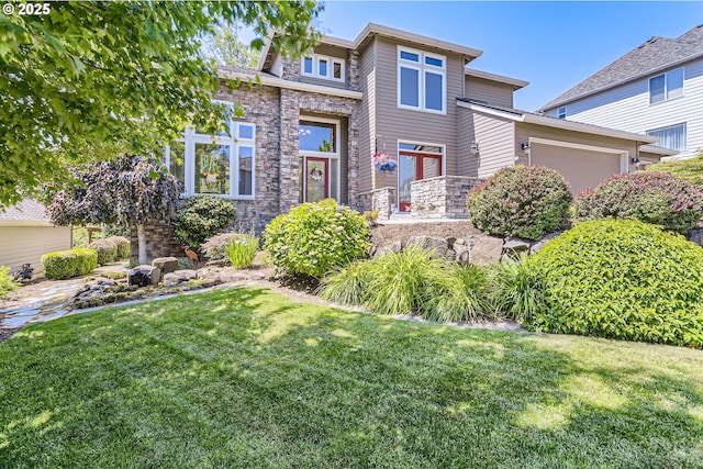 31235 SW Willamette Way, Wilsonville, OR 97070 - view of front of property featuring stone siding, a front yard, and an attached garage
