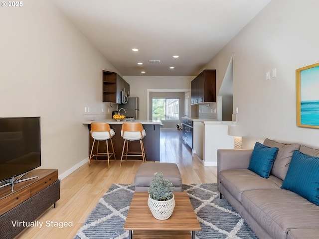 10442 SW Akilean Ter, Portland, OR 97223 - living room featuring light wood-type flooring, baseboards, and recessed lighting