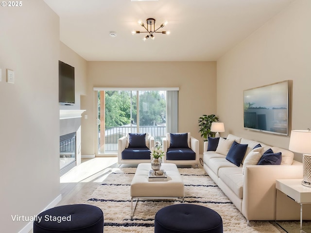 10442 SW Akilean Ter, Portland, OR 97223 - living area with a chandelier, a glass covered fireplace, baseboards, and wood finished floors