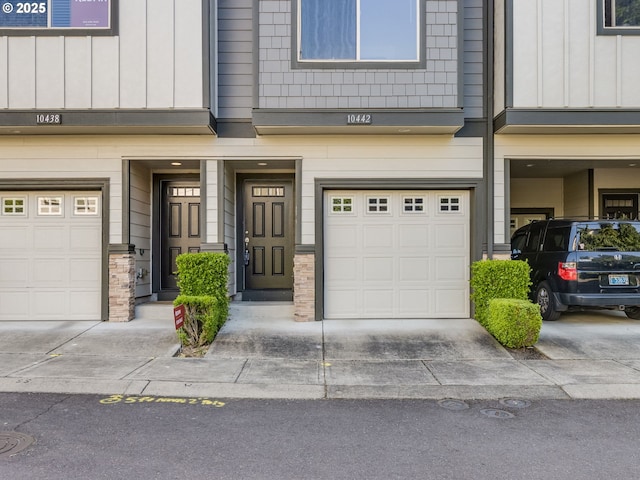 10442 SW Akilean Ter, Portland, OR 97223 - property entrance featuring an attached garage, board and batten siding, and driveway