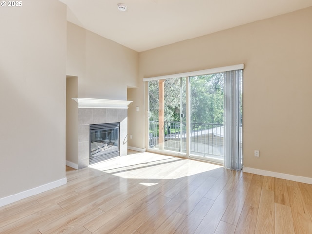 10442 SW Akilean Ter, Portland, OR 97223 - unfurnished living room with wood finished floors, baseboards, and a tile fireplace