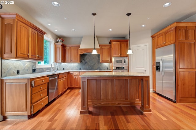 kitchen featuring sink, hanging light fixtures, stainless steel appliances, a center island, and custom exhaust hood