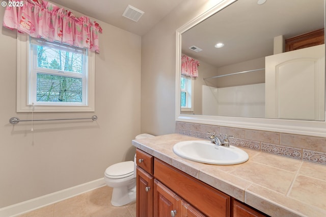 bathroom featuring tile patterned floors, toilet, and vanity