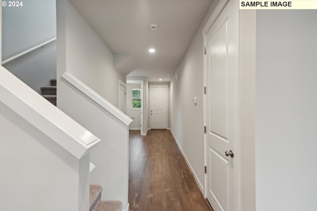 hall with recessed lighting, dark wood-style flooring, baseboards, and stairs