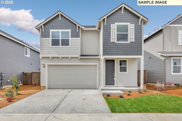 view of front of home with a garage, concrete driveway, and fence