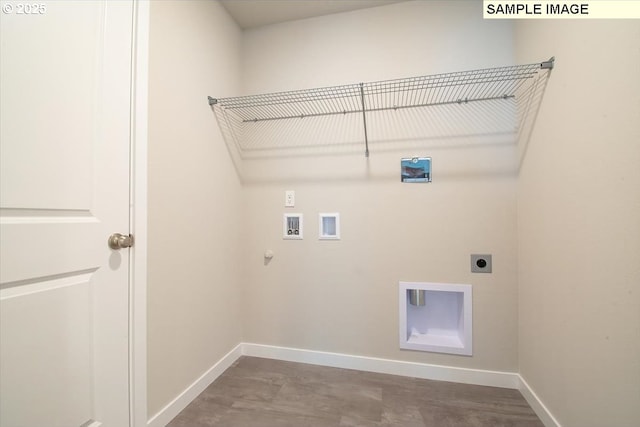 clothes washing area featuring gas dryer hookup, hookup for a washing machine, laundry area, baseboards, and electric dryer hookup