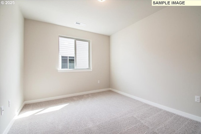 carpeted empty room with baseboards and visible vents