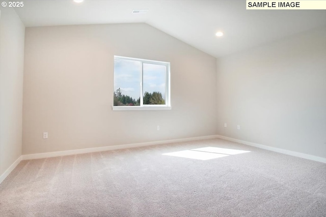 carpeted empty room featuring lofted ceiling, recessed lighting, and baseboards