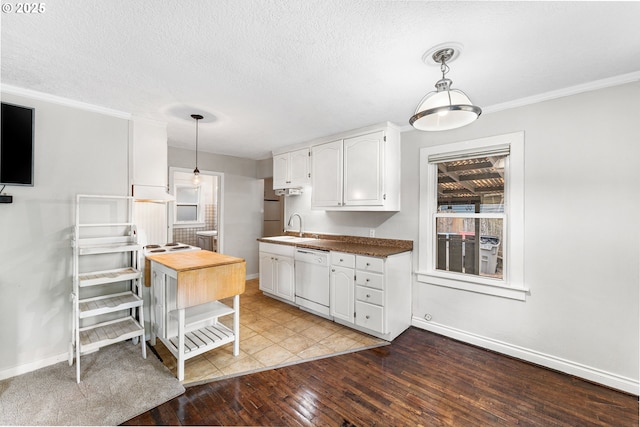 kitchen with light wood-style floors, white dishwasher, baseboards, white cabinetry, and a sink