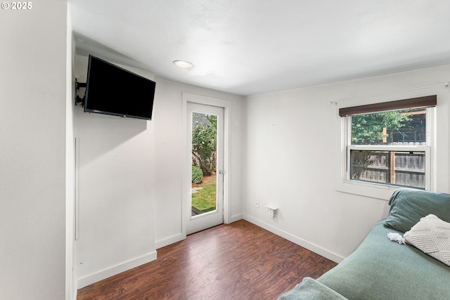interior space with baseboards and wood finished floors