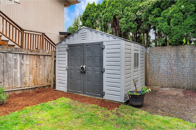 view of shed with a fenced backyard