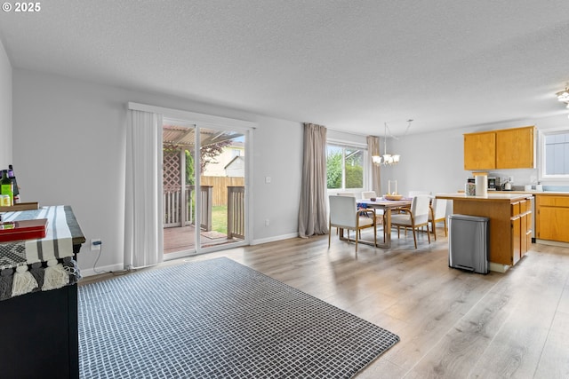 15302 NE 88th St, Vancouver, WA 98682 - kitchen featuring a textured ceiling, light wood-style flooring, a chandelier, a center island, and light countertops