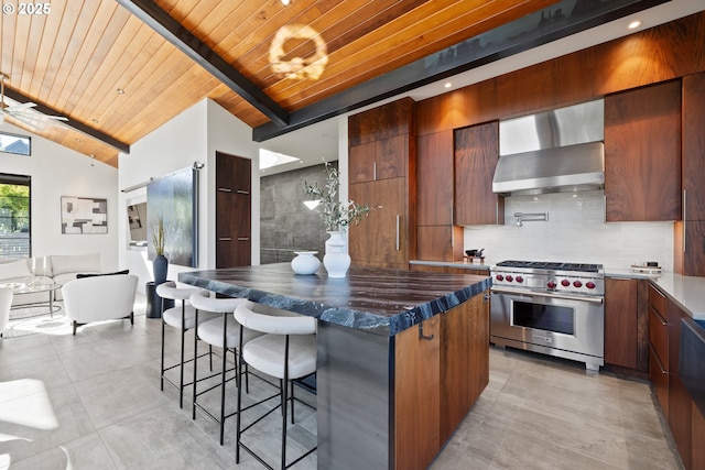 kitchen with modern cabinets, luxury stove, wall chimney exhaust hood, wooden ceiling, and lofted ceiling with beams