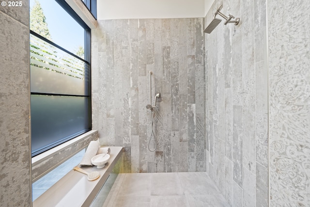 bathroom with a tile shower