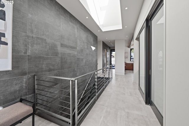 hall featuring a skylight and recessed lighting
