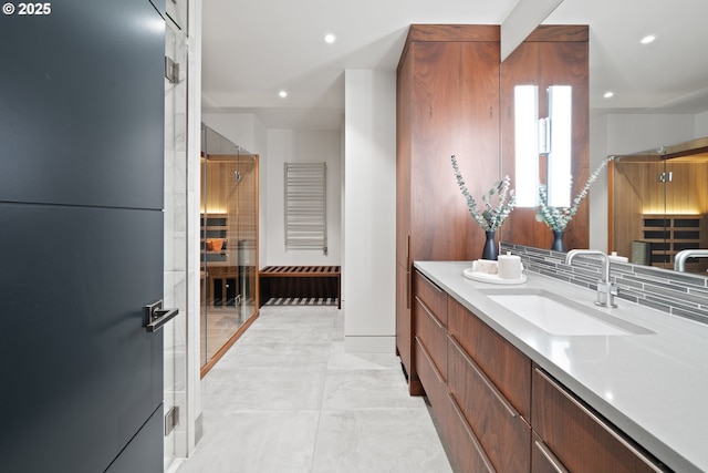 full bathroom featuring vanity, recessed lighting, baseboards, and an enclosed shower