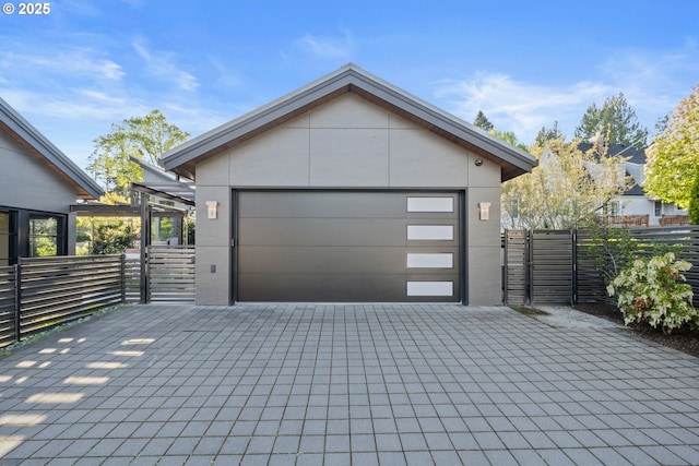 detached garage featuring fence