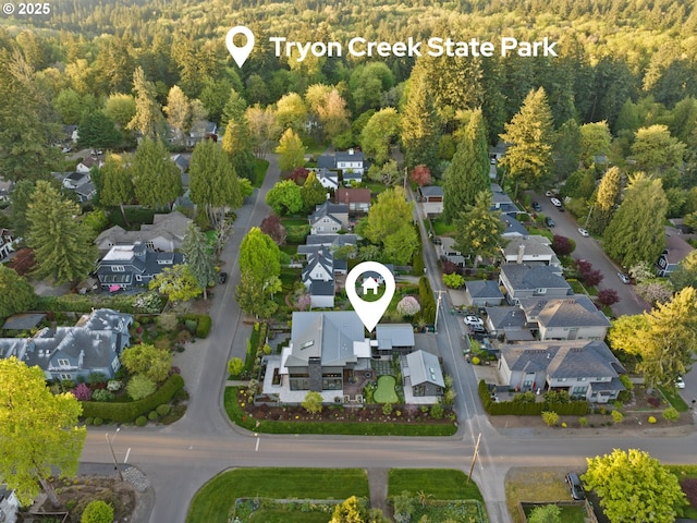 birds eye view of property featuring a residential view and a view of trees