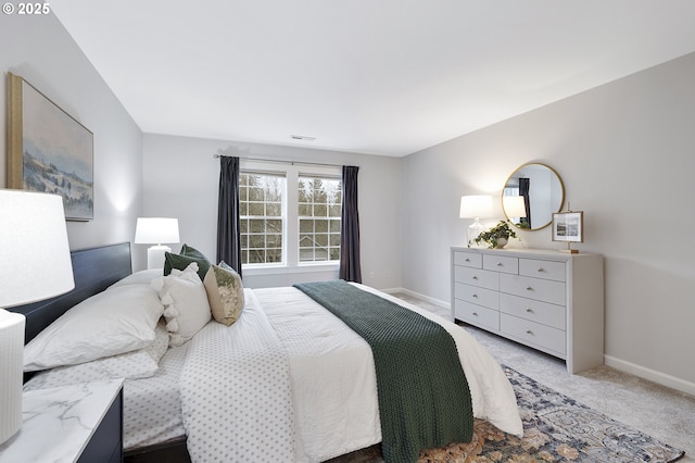 bedroom featuring visible vents, baseboards, and light colored carpet