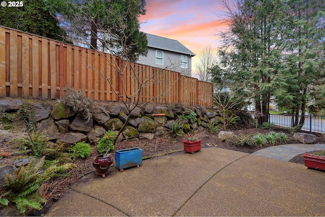 view of yard featuring fence and a patio