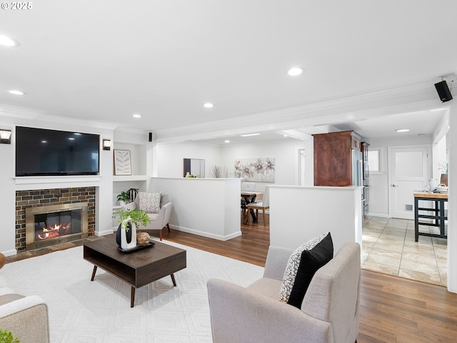 8920 SW 9th Dr, Portland, OR 97219 - living area featuring light wood-style flooring, recessed lighting, ornamental molding, and a brick fireplace