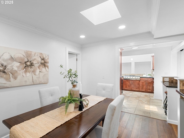 8920 SW 9th Dr, Portland, OR 97219 - dining room featuring recessed lighting, ornamental molding, a skylight, light wood-type flooring, and baseboards