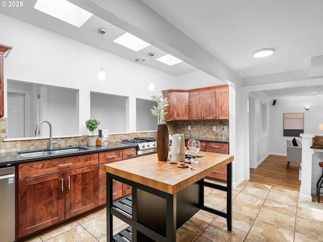 8920 SW 9th Dr, Portland, OR 97219 - kitchen with a skylight, a sink, dishwasher, decorative backsplash, and decorative light fixtures