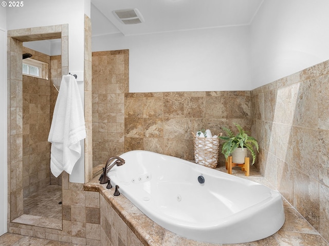 8920 SW 9th Dr, Portland, OR 97219 - bathroom featuring tile walls, a tub with jets, a walk in shower, and a wainscoted wall