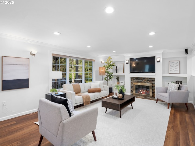8920 SW 9th Dr, Portland, OR 97219 - living area featuring ornamental molding, recessed lighting, a tiled fireplace, wood finished floors, and baseboards