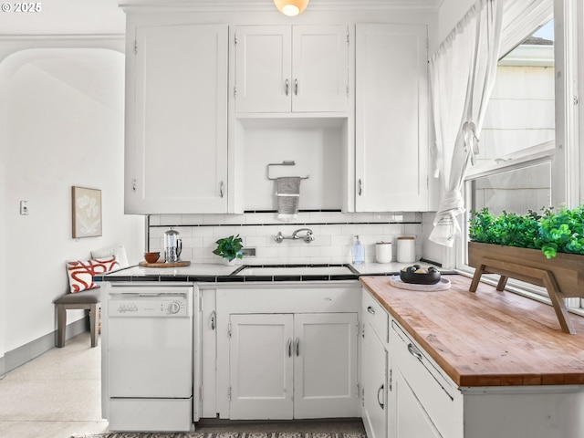 kitchen featuring white cabinetry, white dishwasher, sink, and backsplash