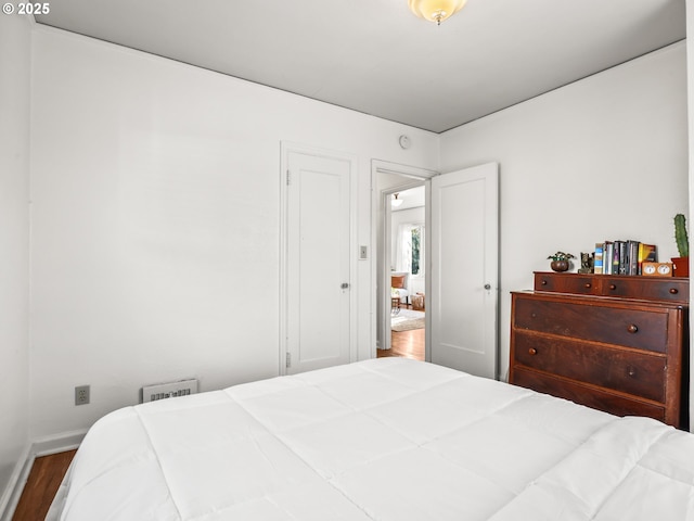 bedroom with hardwood / wood-style flooring