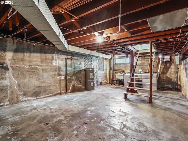 basement featuring sink and strapped water heater