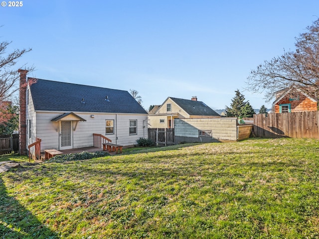 back of house with a lawn