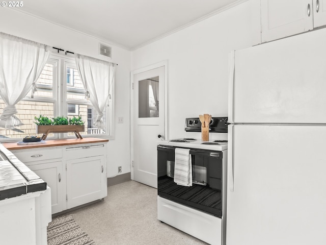 kitchen with electric stove, white cabinetry, tile counters, and white fridge