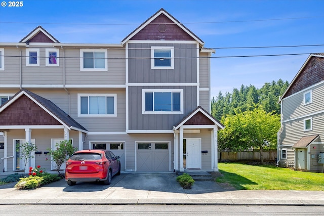 2613 SE 109th Ave, Portland, OR 97266 - view of front facade with driveway, an attached garage, and board and batten siding