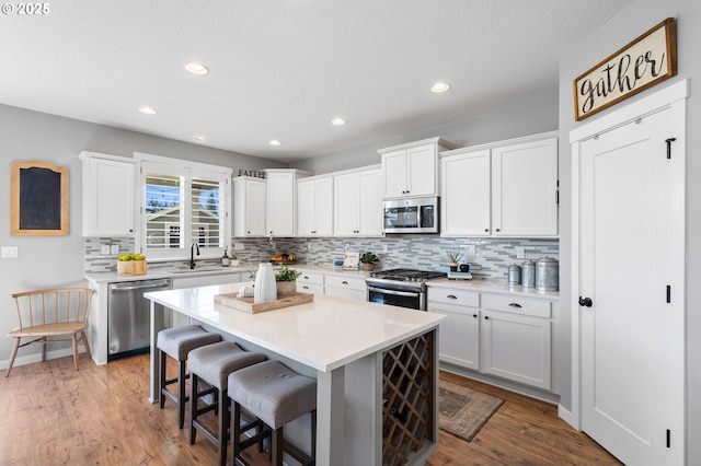 kitchen featuring white cabinetry, appliances with stainless steel finishes, and a center island