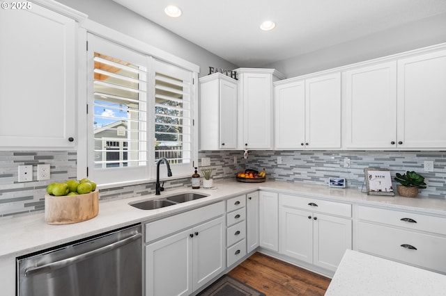 kitchen with sink, backsplash, stainless steel dishwasher, and white cabinets