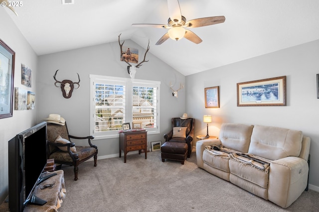 living room featuring lofted ceiling, ceiling fan, and carpet