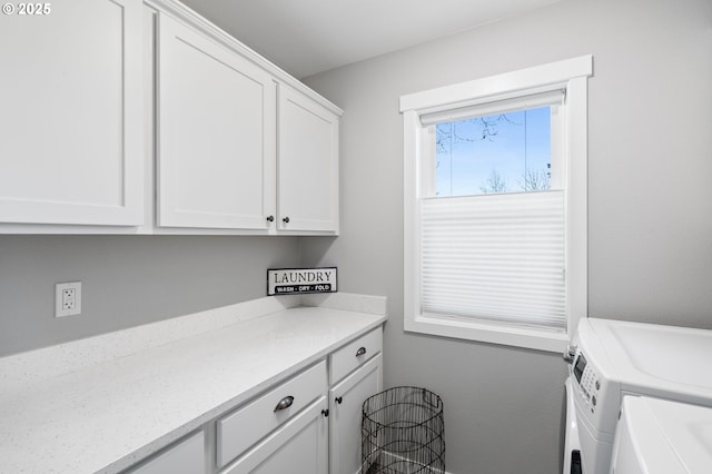 laundry room with cabinets and washing machine and clothes dryer