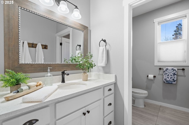 bathroom featuring vanity and toilet