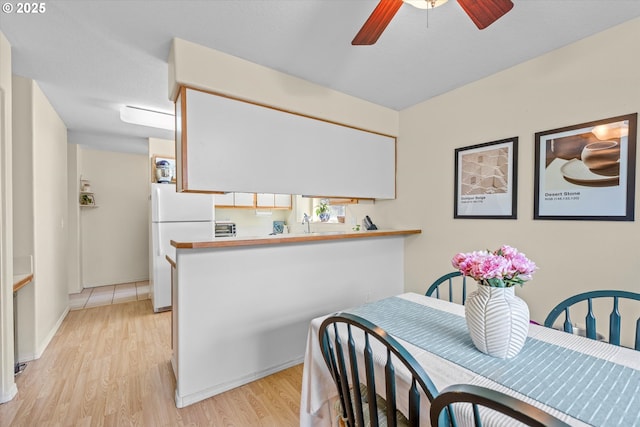 4728 W Powell Blvd Unit 231, Gresham, OR 97030 - dining area with ceiling fan, light wood-style flooring, and baseboards