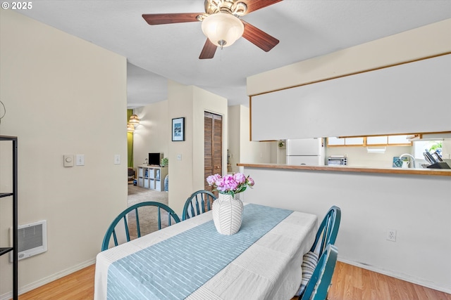 4728 W Powell Blvd Unit 231, Gresham, OR 97030 - dining area with wood finished floors, heating unit, ceiling fan, and baseboards