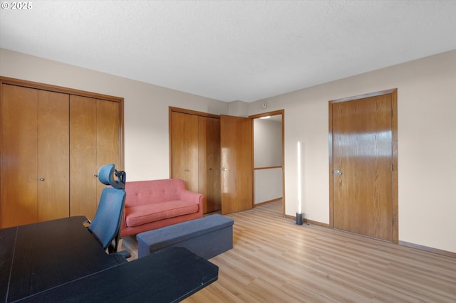 13802 NW 10th Ct, Vancouver, WA 98685 - interior space with baseboards, light wood-type flooring, and a textured ceiling