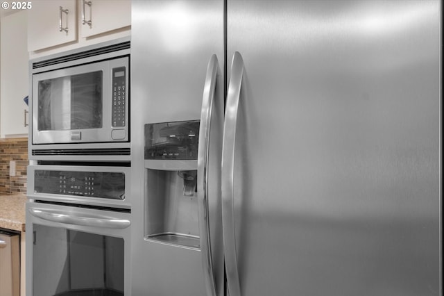 13802 NW 10th Ct, Vancouver, WA 98685 - interior details featuring tasteful backsplash, light countertops, white cabinetry, and stainless steel appliances