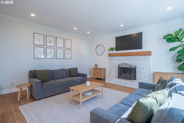 8751 SW 194th Pl, Beaverton, OR 97007 - living area with ornamental molding, wood finished floors, recessed lighting, a fireplace, and wooden walls