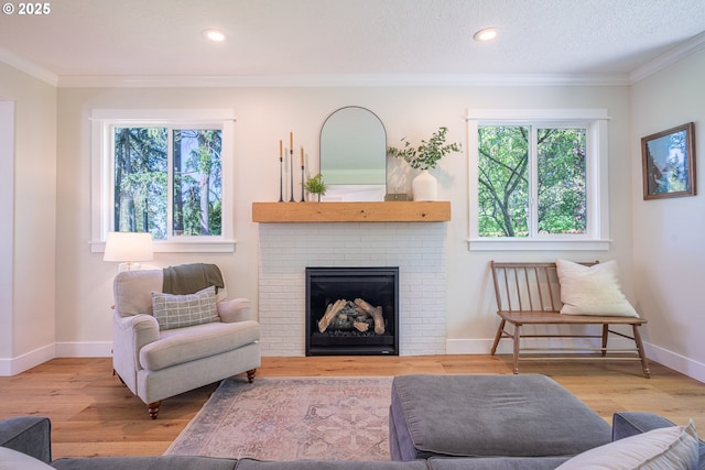 8751 SW 194th Pl, Beaverton, OR 97007 - living room with healthy amount of natural light, crown molding, wood finished floors, a fireplace, and recessed lighting