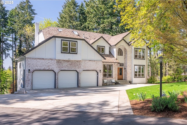 8751 SW 194th Pl, Beaverton, OR 97007 - view of front of house featuring a chimney, brick siding, board and batten siding, concrete driveway, and an attached garage